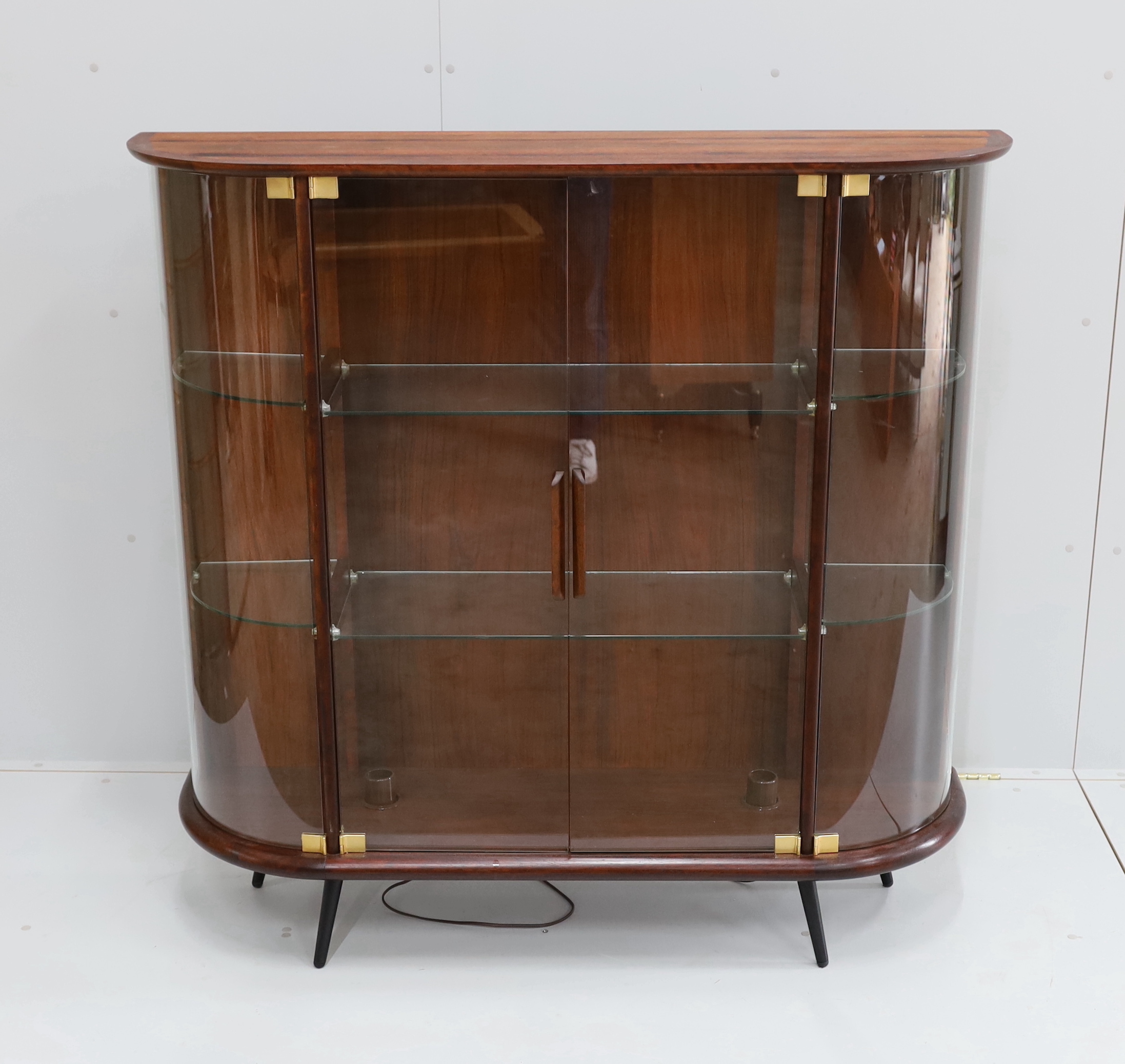 A mid century Indian rosewood glazed display cabinet with lighting, width 133cm, depth 36cm, height 130cm